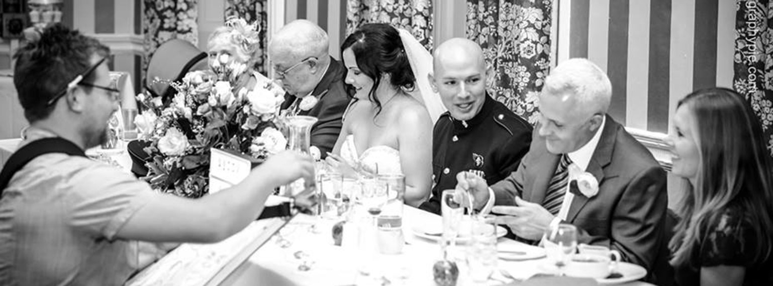 caricaturist going along the top table and drawing everyone