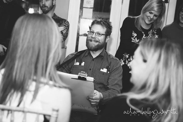 two blondes and a bearded caricaturist