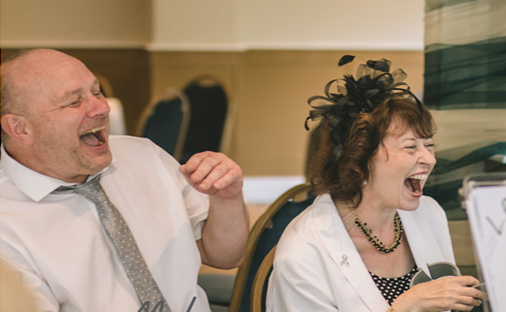 laughing out loud after seeing their caricature