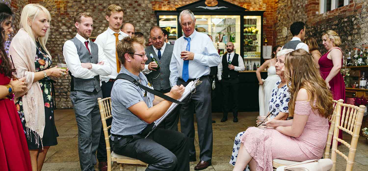 the caricature artist is caricaturing the guests at the gala dinner and is a crowd pleaser