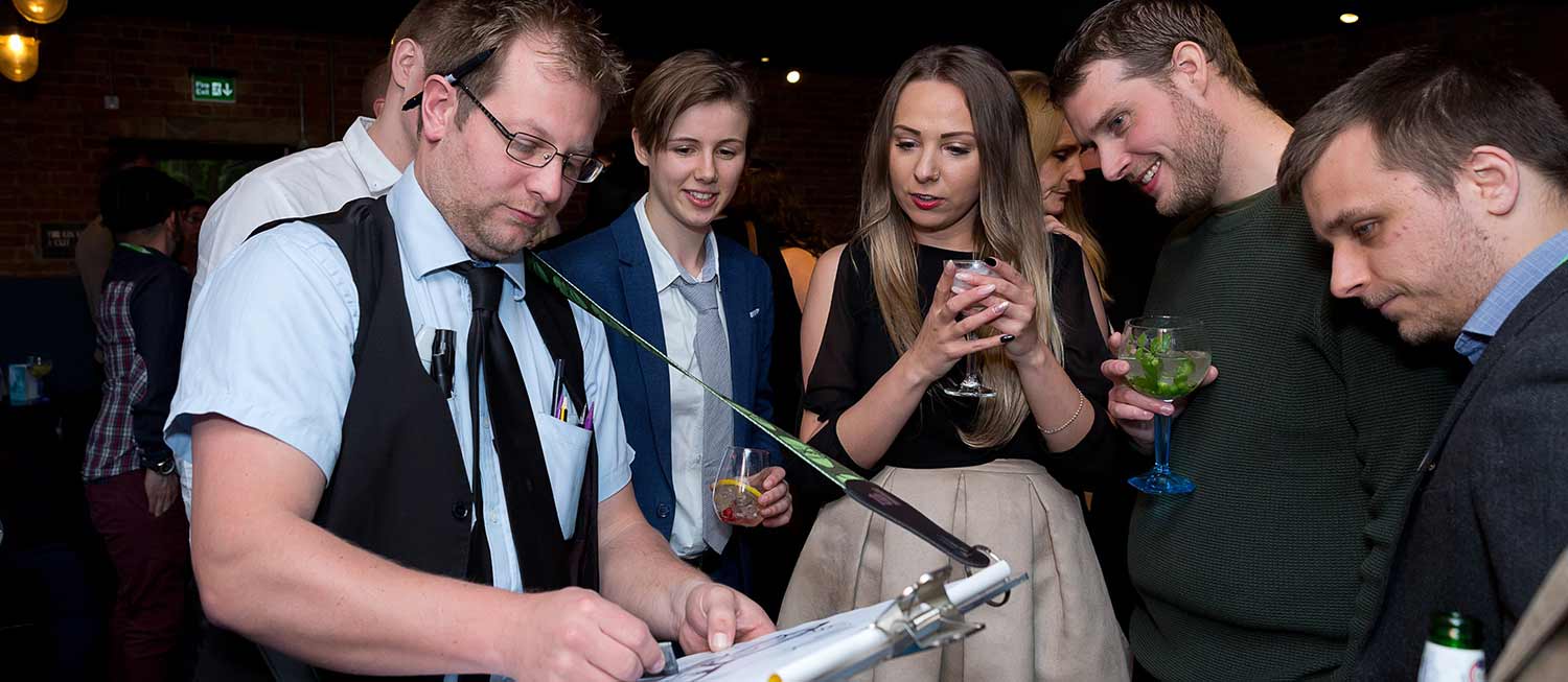 Caricaturist with easel attached drawing caricatures at a Corporate event