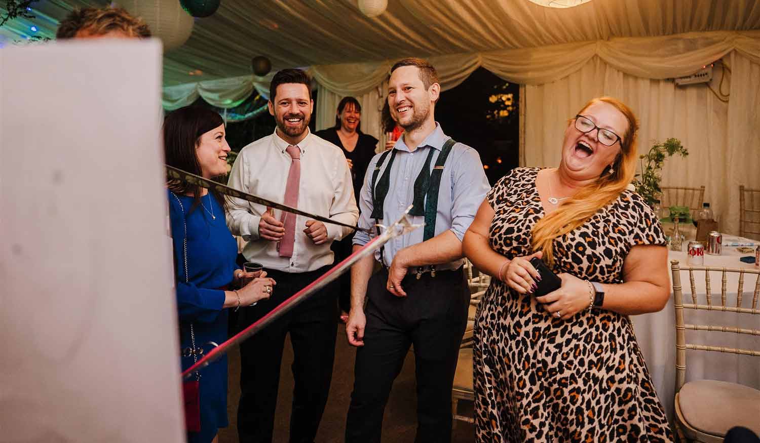 A woman laughing hard after seeing her caricature